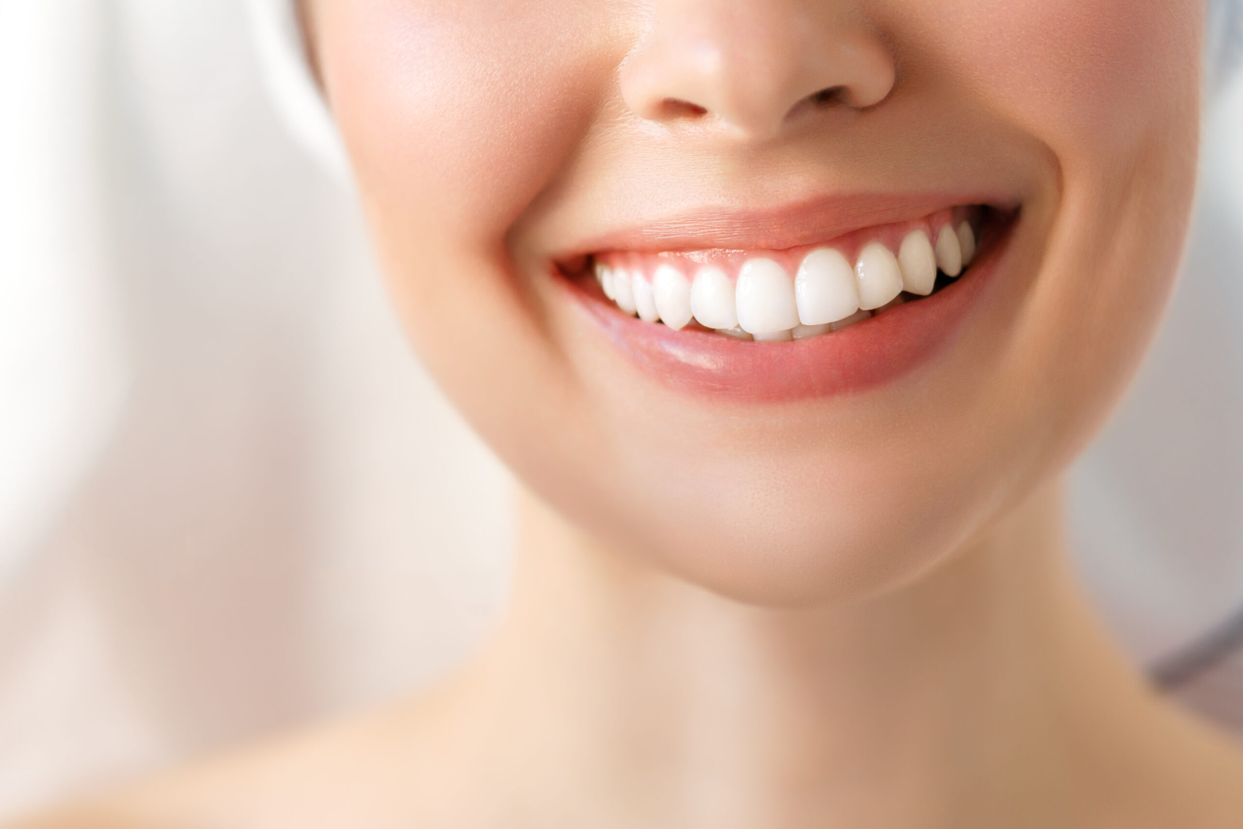 Perfect healthy teeth smile of a young woman. Teeth whitening. Dental clinic patient. Image symbolizes oral care dentistry, stomatology.